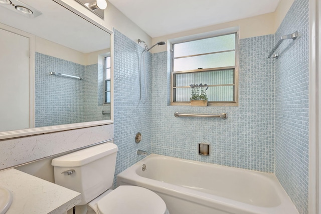 full bathroom with tiled shower / bath combo, toilet, and vanity