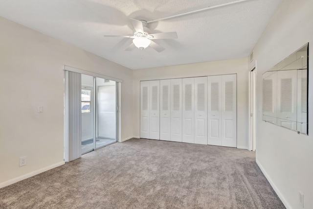 unfurnished bedroom featuring access to outside, ceiling fan, carpet, and a textured ceiling