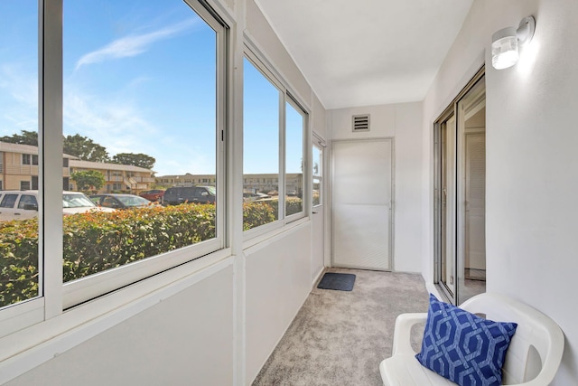 unfurnished bedroom featuring carpet, a textured ceiling, and multiple closets