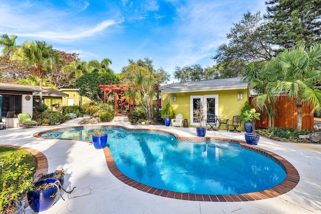 view of pool with french doors, a patio, and a pergola