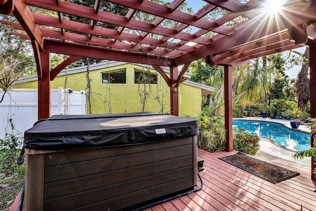 wooden terrace with a swimming pool with hot tub and a pergola