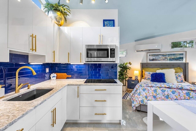 bedroom featuring light tile patterned floors, a wall mounted AC, and sink