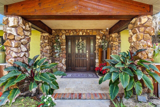 view of exterior entry with covered porch