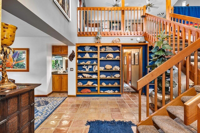 stairway featuring a high ceiling and tile patterned floors