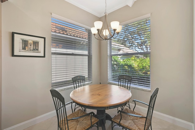 dining area featuring ornamental molding, a wealth of natural light, a notable chandelier, and light tile patterned flooring