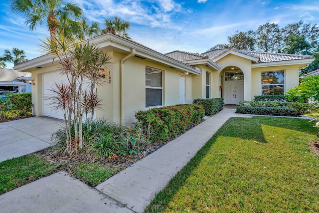 view of front of property with a front lawn and a garage