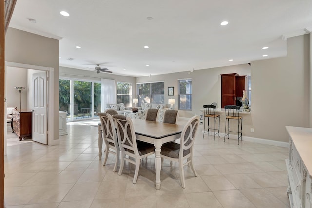 tiled dining space with ceiling fan