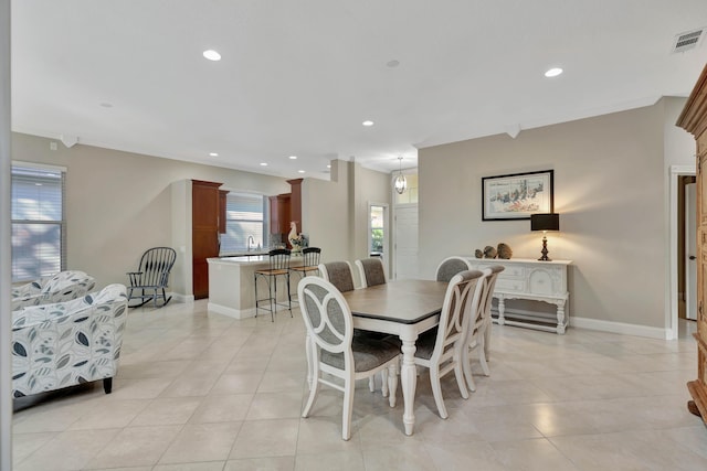 dining area with light tile patterned floors and sink