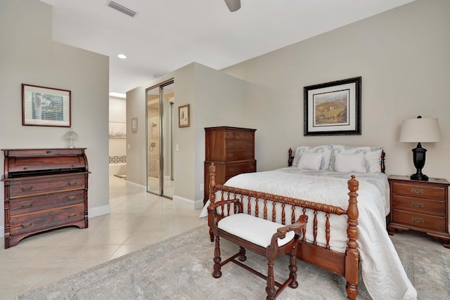 bedroom with ceiling fan, light tile patterned flooring, and connected bathroom