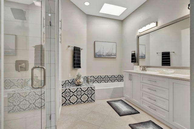 bathroom with tile patterned floors, a skylight, vanity, and plus walk in shower