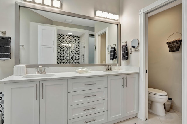 bathroom featuring tile patterned floors, a shower, vanity, and toilet