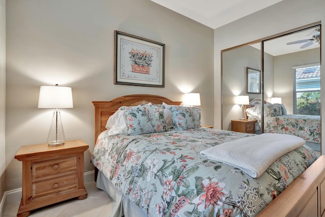 tiled bedroom with ceiling fan and a closet