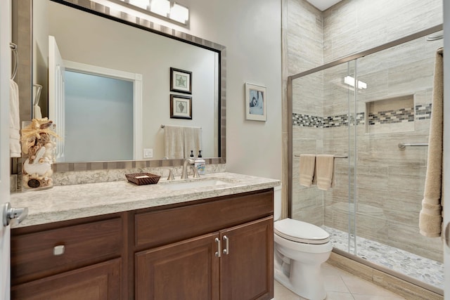 bathroom featuring tile patterned floors, vanity, toilet, and an enclosed shower