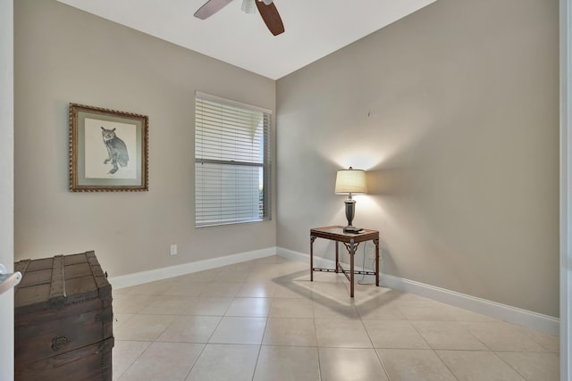 living area featuring ceiling fan and light tile patterned flooring