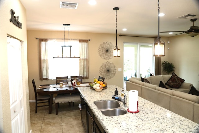 kitchen with a wealth of natural light, hanging light fixtures, and sink