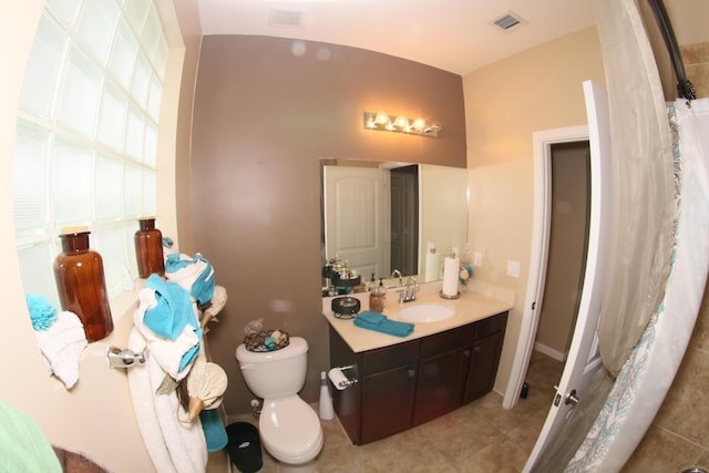 bathroom featuring tile patterned floors, vanity, and toilet