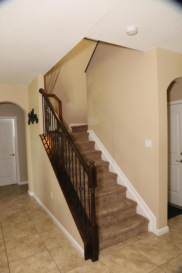 staircase with tile patterned flooring