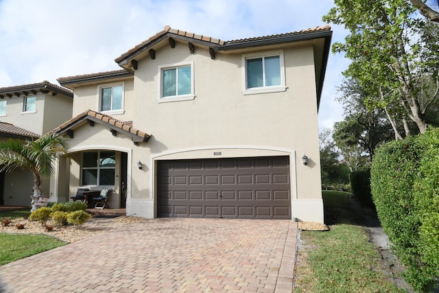 mediterranean / spanish-style home featuring a garage