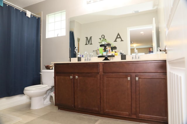 bathroom with tile patterned flooring, vanity, and toilet