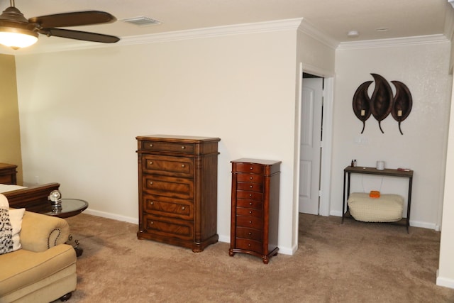 sitting room with crown molding, carpet, and ceiling fan