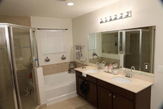 bathroom featuring vanity, separate shower and tub, and a textured ceiling