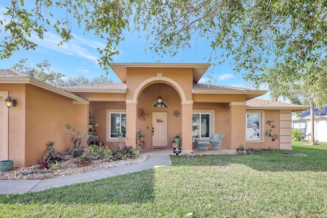 property entrance with a lawn