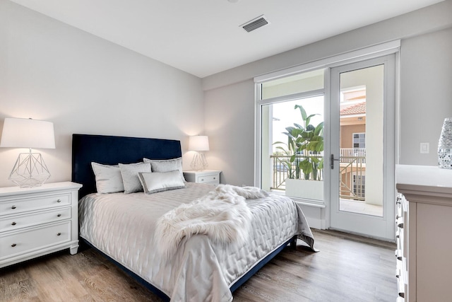 bedroom featuring dark hardwood / wood-style flooring and access to outside