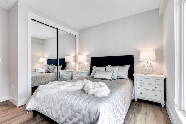 bedroom featuring light wood-type flooring and a closet