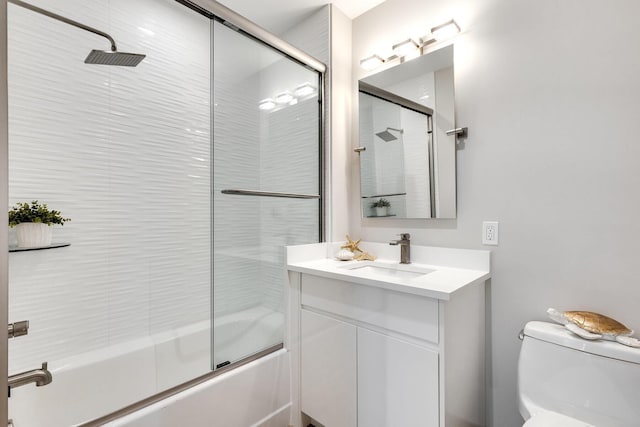 full bathroom with vanity, toilet, and bath / shower combo with glass door