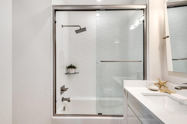 bathroom with shower / bath combination with glass door and vanity