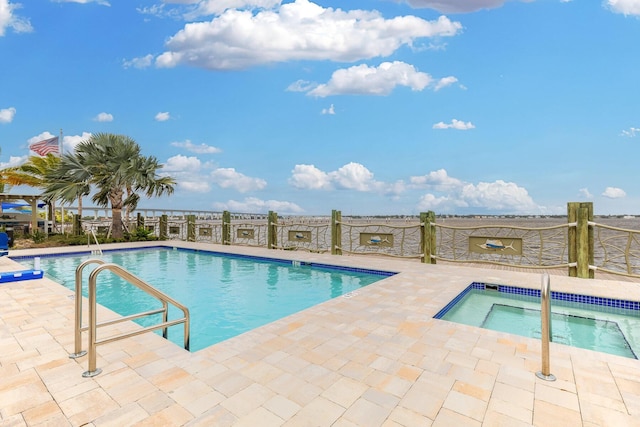 view of pool with a patio area and a hot tub