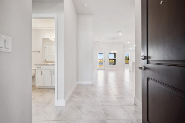 hallway featuring an inviting chandelier