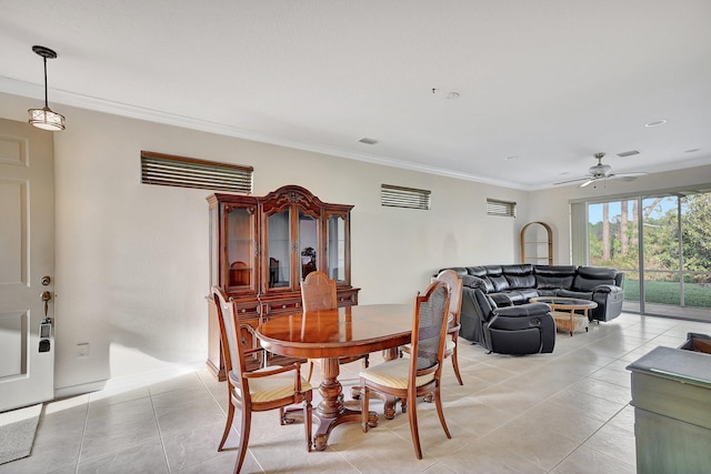 dining space featuring light tile patterned floors, ceiling fan, and ornamental molding