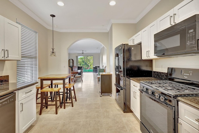 kitchen with black appliances, pendant lighting, and white cabinets