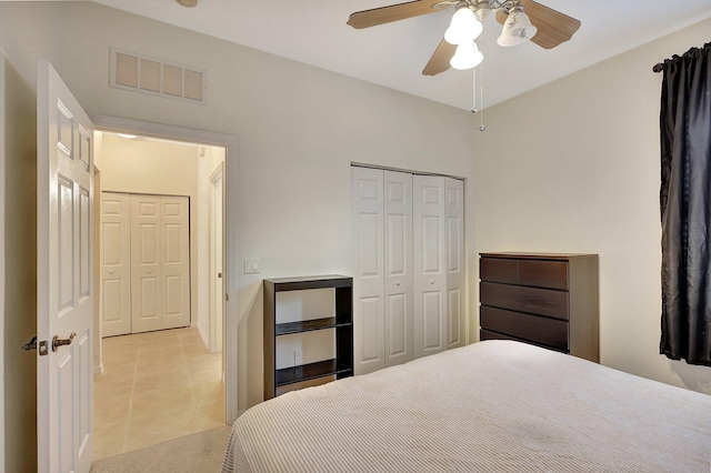 tiled bedroom with ceiling fan