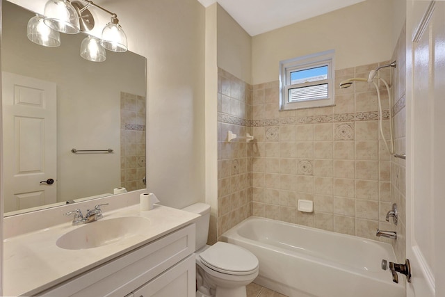 full bathroom with vanity, tiled shower / bath combo, and toilet