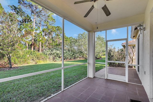 unfurnished sunroom with ceiling fan