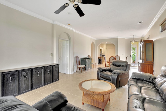 living room featuring light tile patterned floors, ceiling fan, and crown molding