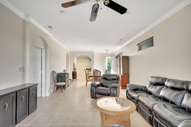 tiled living room with ceiling fan and ornamental molding