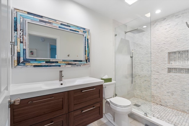 bathroom featuring tile patterned flooring, vanity, toilet, and an enclosed shower