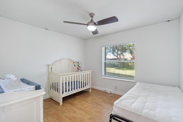 bedroom with ceiling fan and light hardwood / wood-style flooring