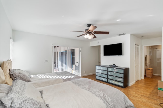 bedroom with ceiling fan, a closet, light hardwood / wood-style flooring, and ensuite bath