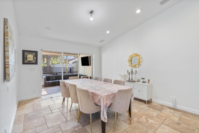 dining room with lofted ceiling