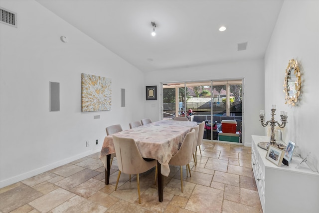 dining area with vaulted ceiling