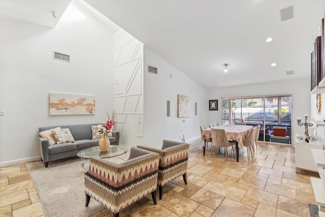 living room with high vaulted ceiling