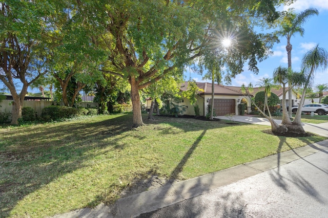 view of front of property with a front yard and a garage