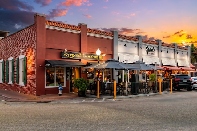 view of outdoor building at dusk