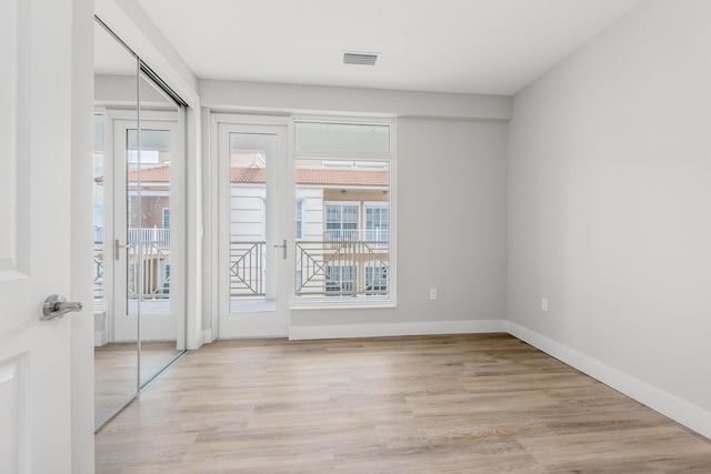 unfurnished room with light hardwood / wood-style flooring