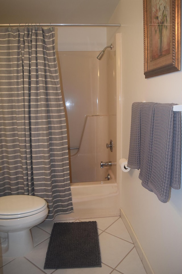 bathroom featuring tile patterned floors, toilet, and shower / tub combo