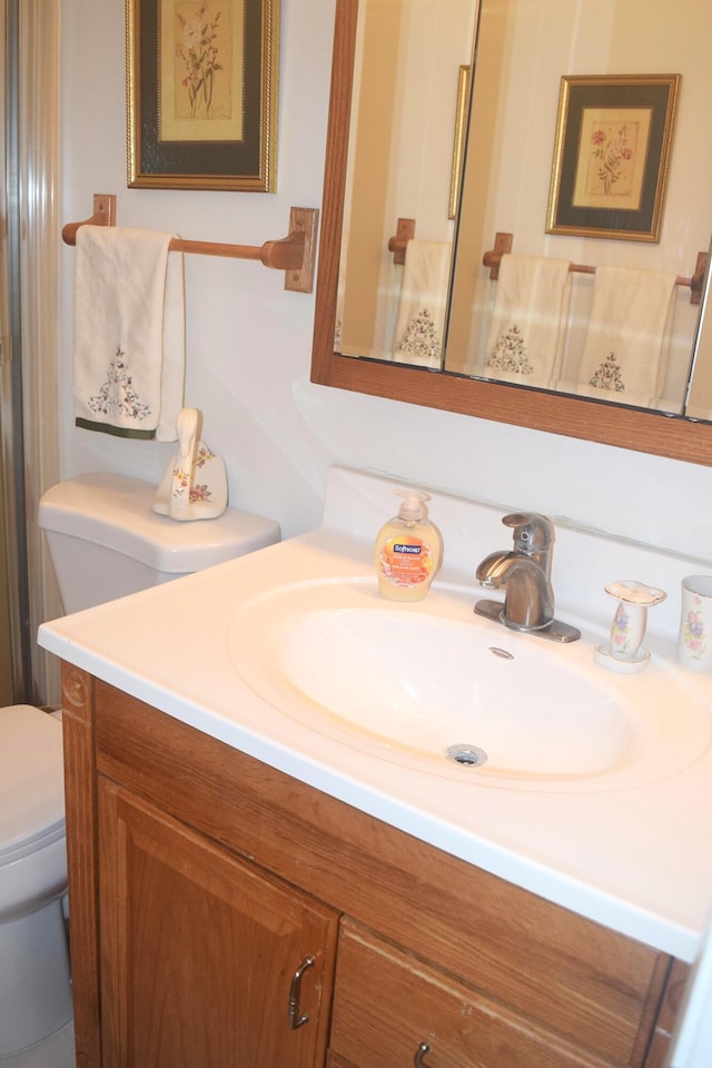 bathroom featuring vanity and toilet